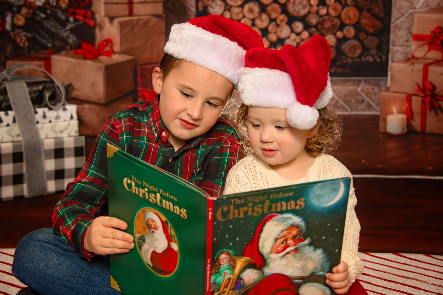 Children in holiday attire read Christmas storybooks together in a festive setting and decorations.