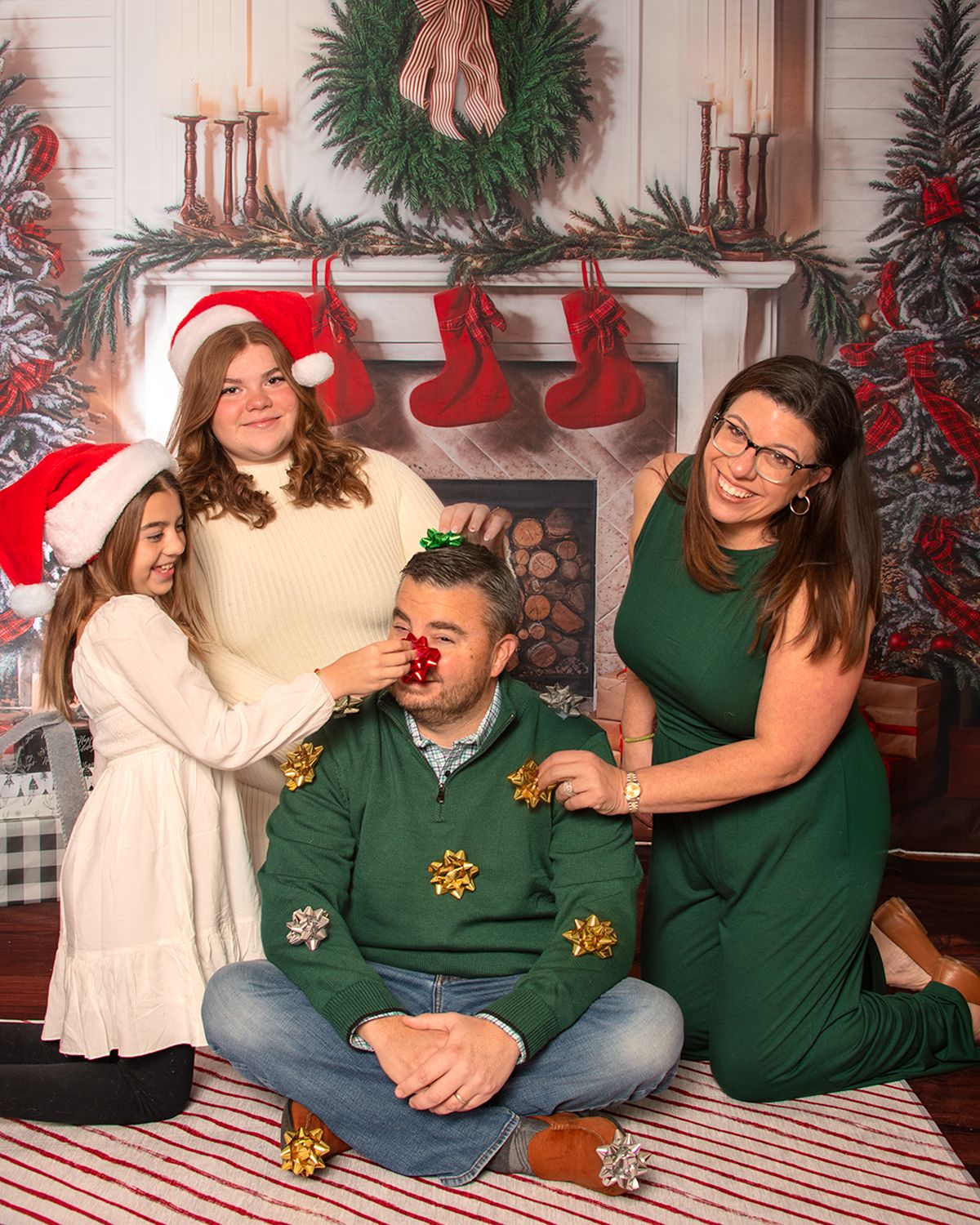 Christmas with family putting bows all over dad