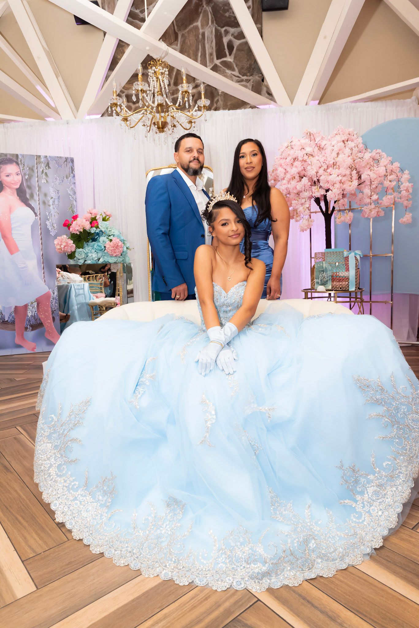 Elegant ballgown session in a venue with cherry blossoms and chandeliers.