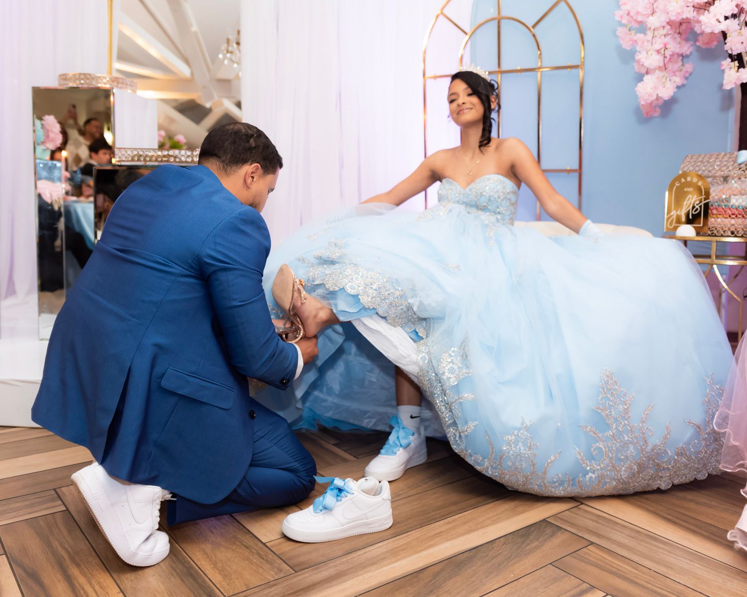 Studio session with romantic cherry blossom decor and blue formal attire.