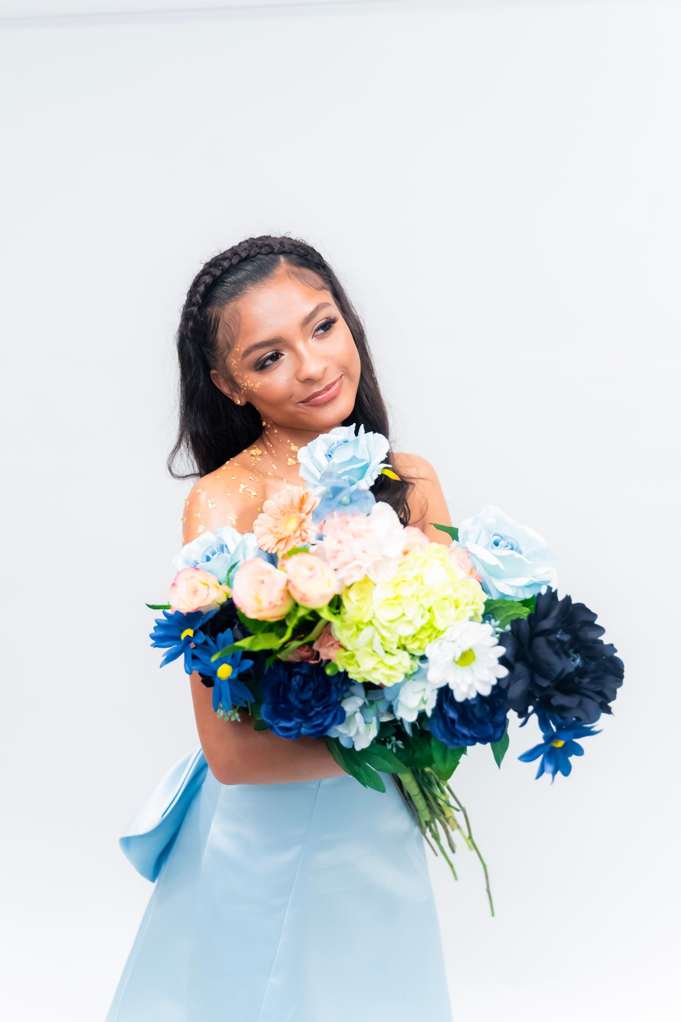 Artistic photo series with colorful flowers and light blue dress against white background.