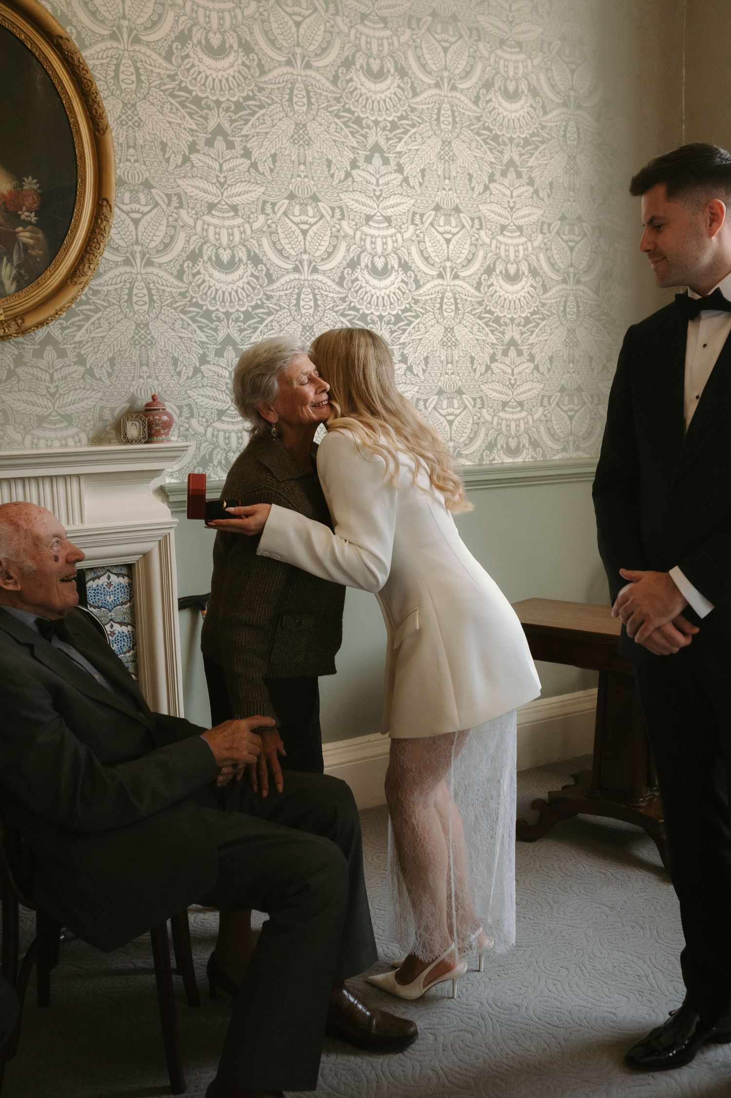 A series of candid moments captured at a formal gathering showing interactions in an elegant room with patterned wallpaper.
