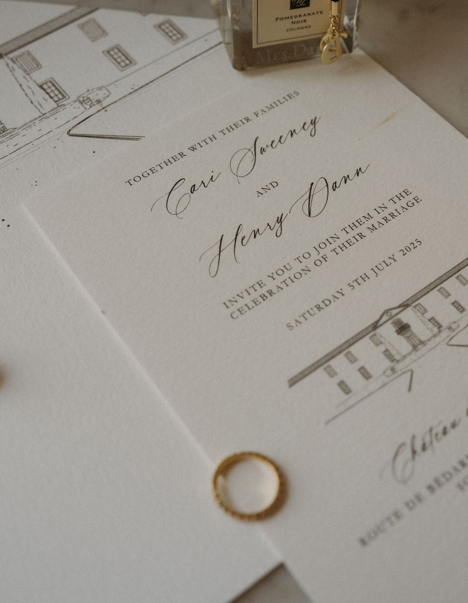 Wedding invitation details printed in elegant calligraphy on white paper with a soft golden ring accent.