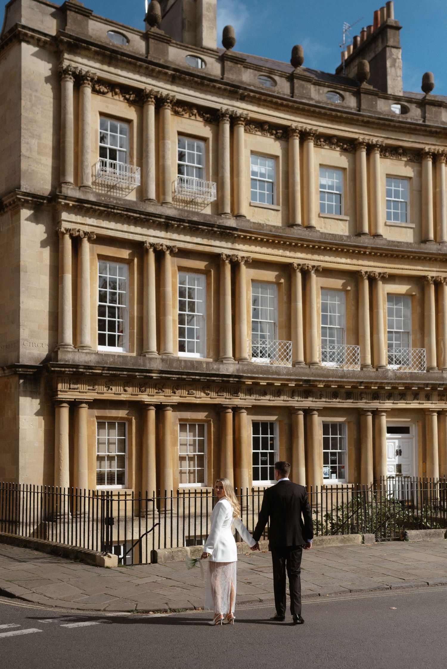 Elegant Georgian architecture of The Royal Crescent in Bath with ornate columns and windows along the curved facade.