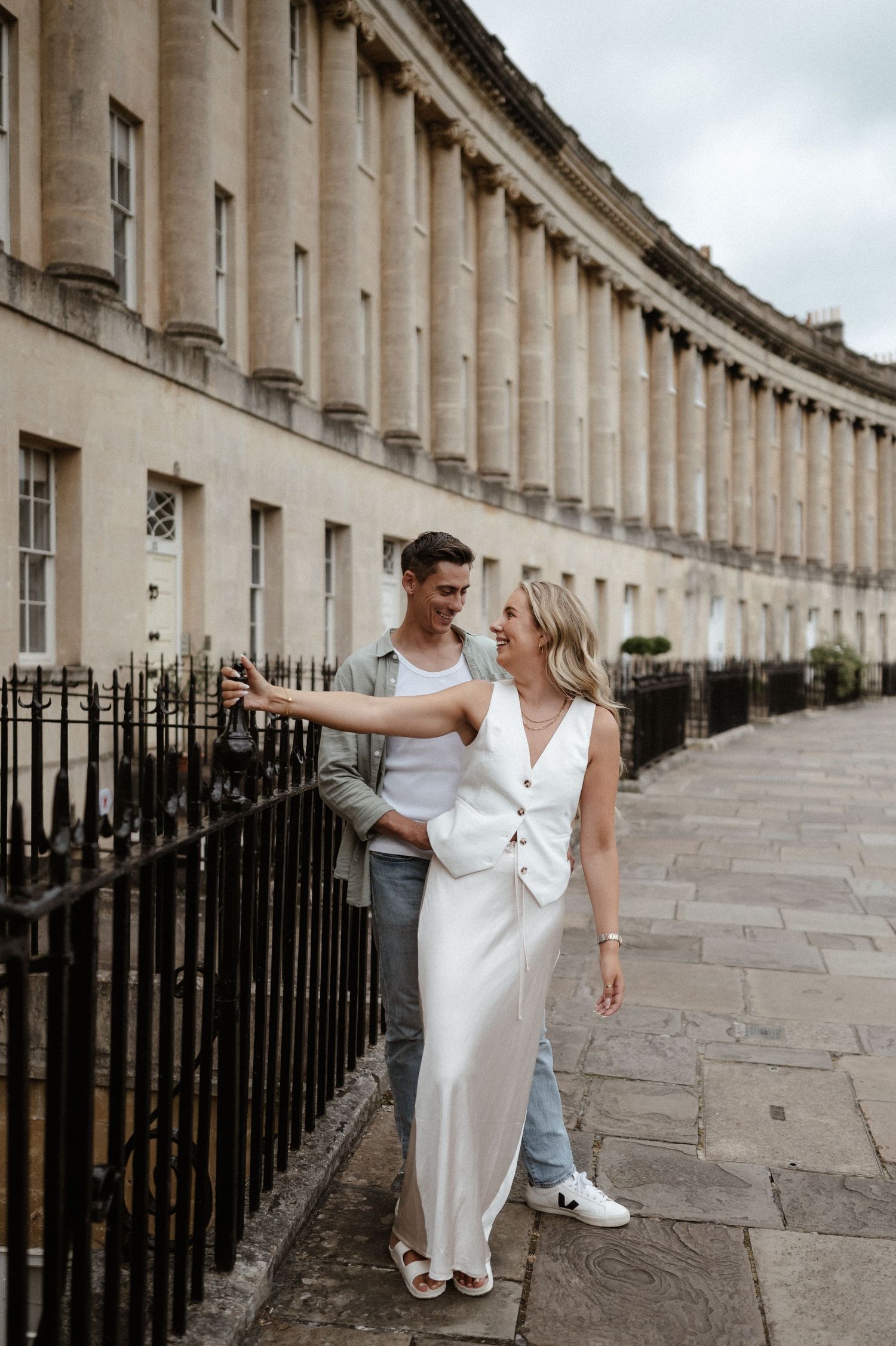 A couple shares a romantic moment along the iconic Royal Crescent in Bath.