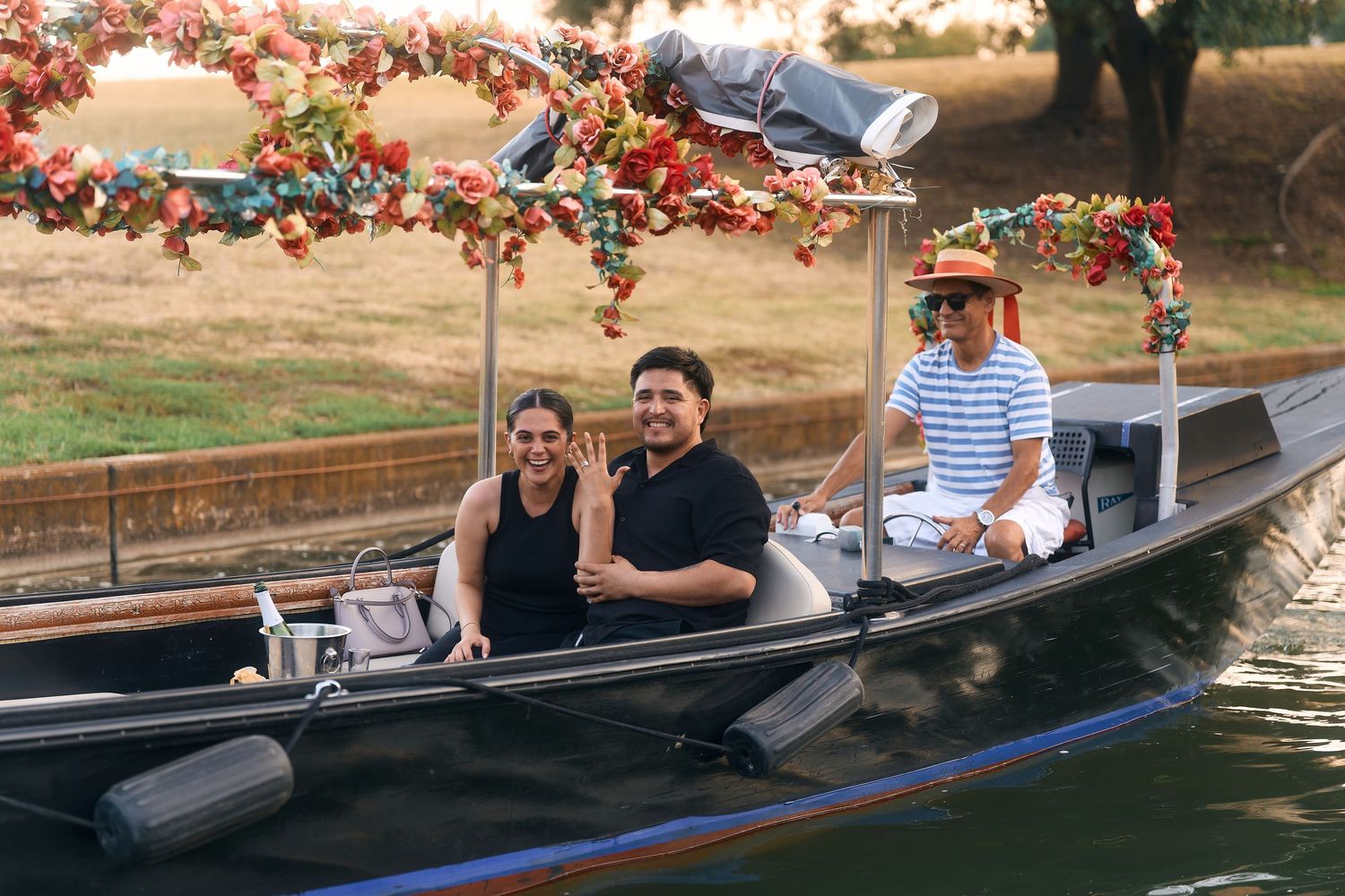 Group enjoying boat ride with festive decorations on calm waters.