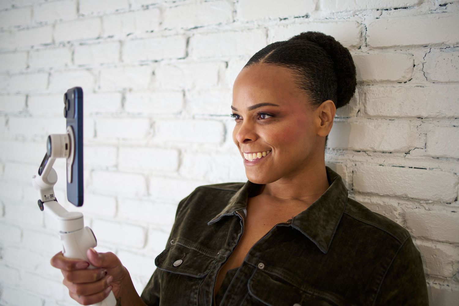 Series of casual portraits against white brick wall showing expressions and poses.