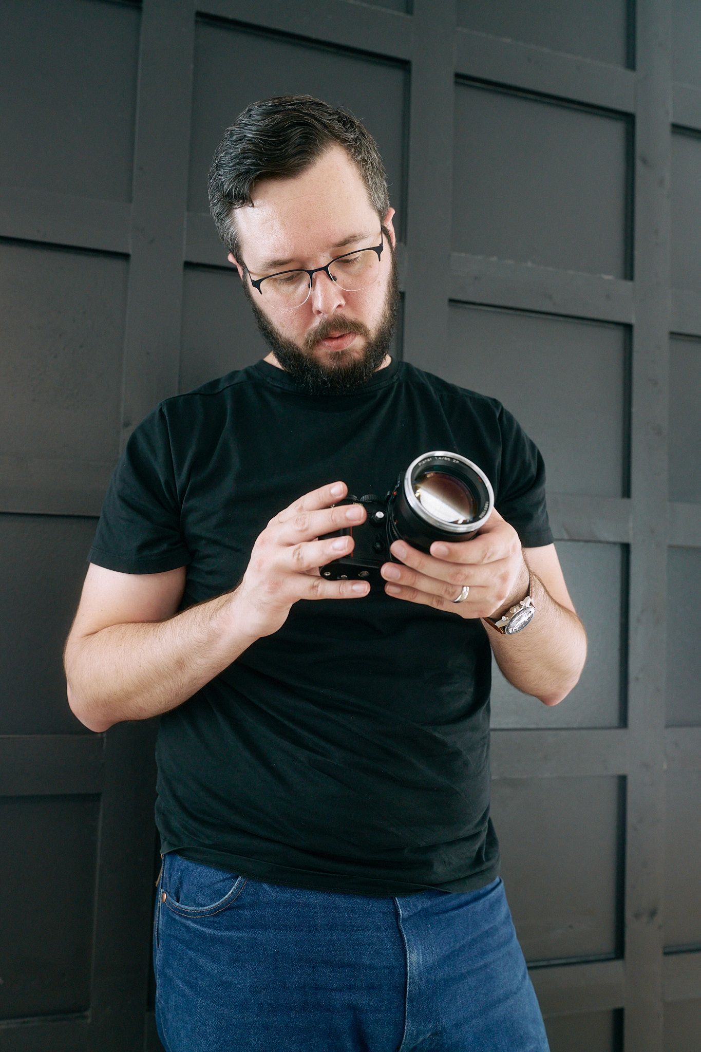 Series of photos showing someone in black shirt examining a small round object against dark background.