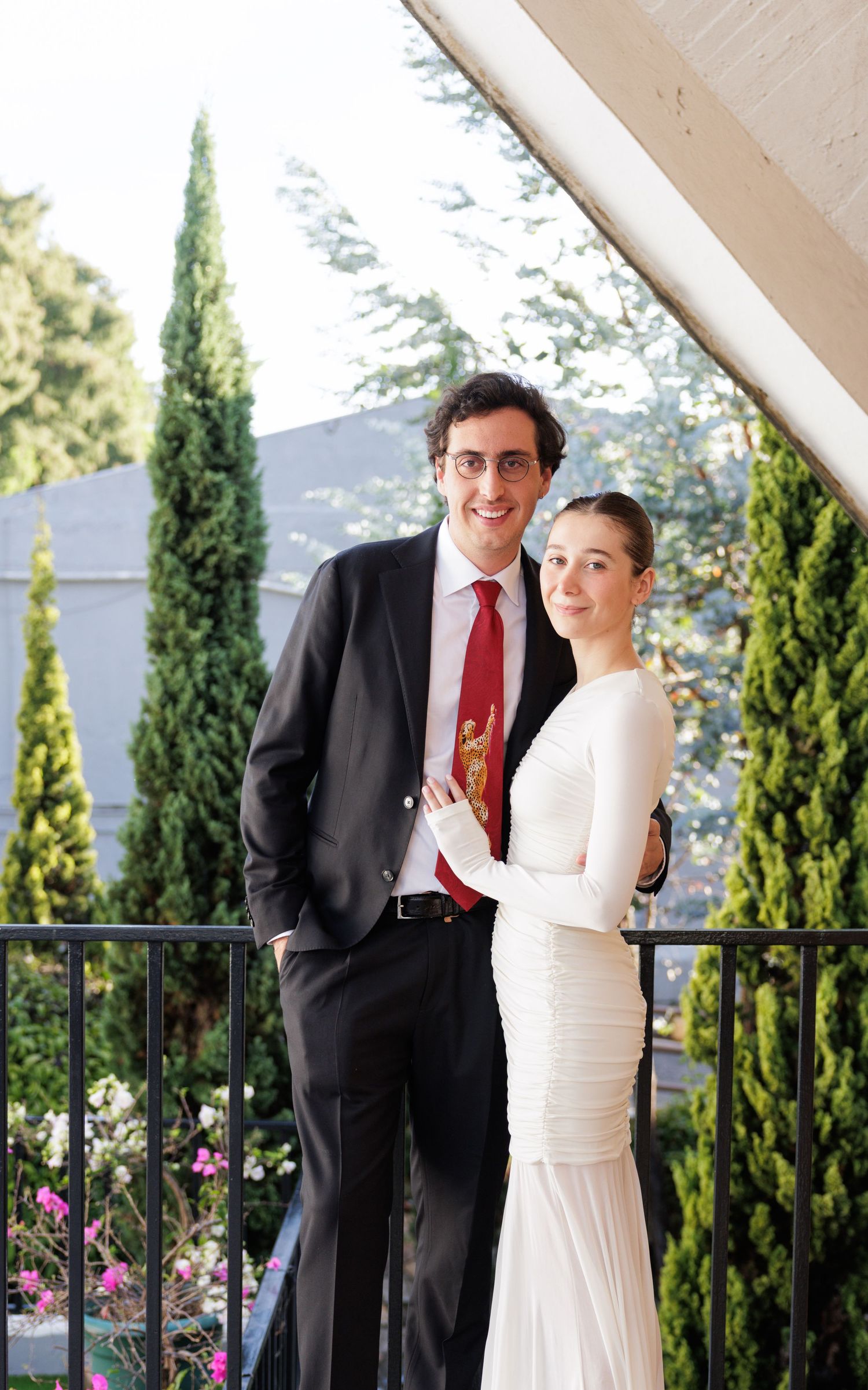 Elegant outdoor wedding portraits with cypress trees in the background.