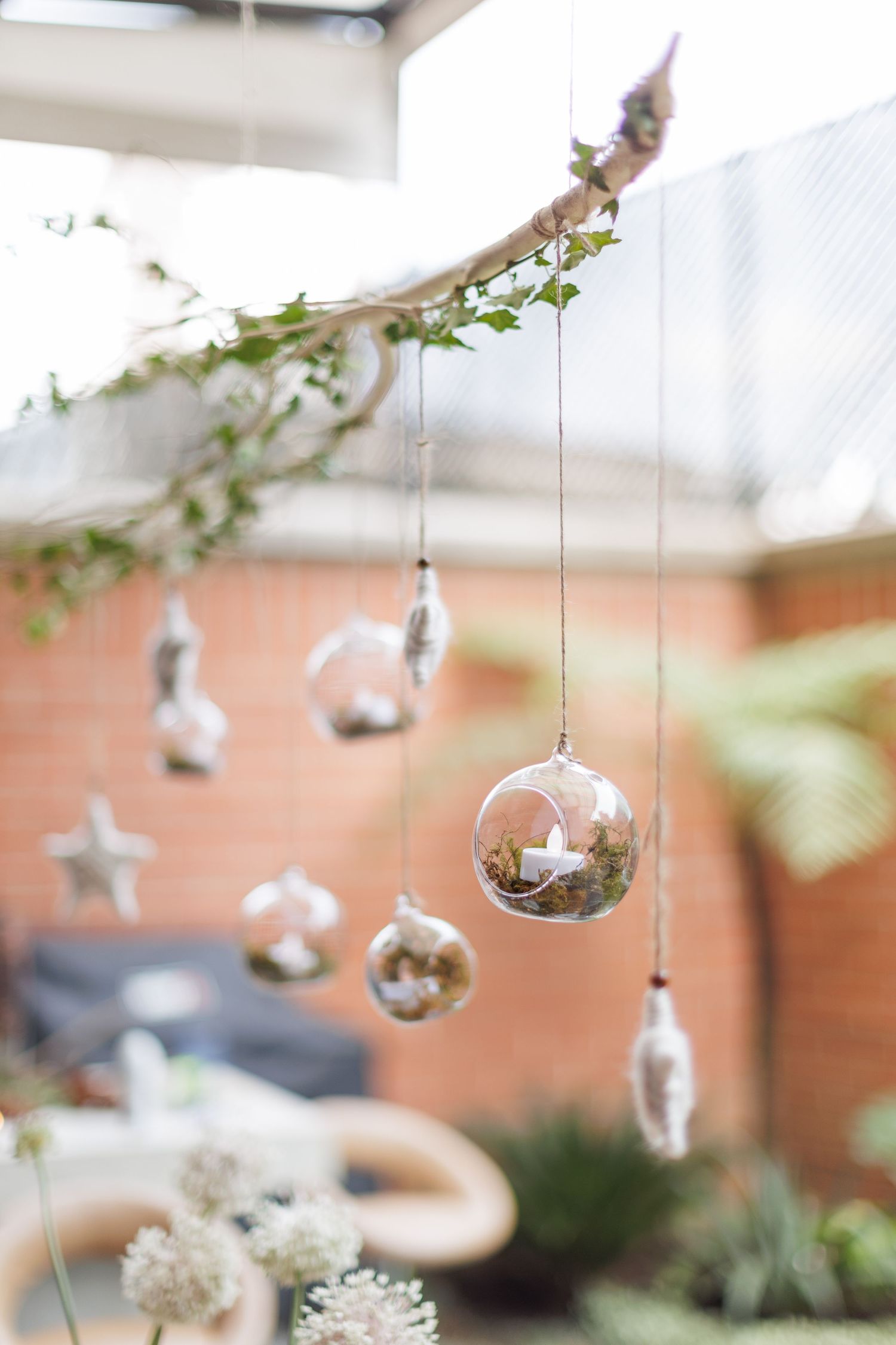Decorative silver baubles and greenery hanging from the ceiling create an ethereal wedding atmosphere.