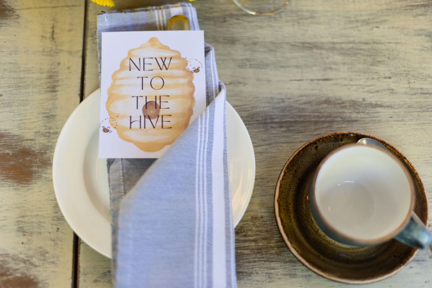 Restaurant table setting with white napkins and menus on rustic wooden surface.