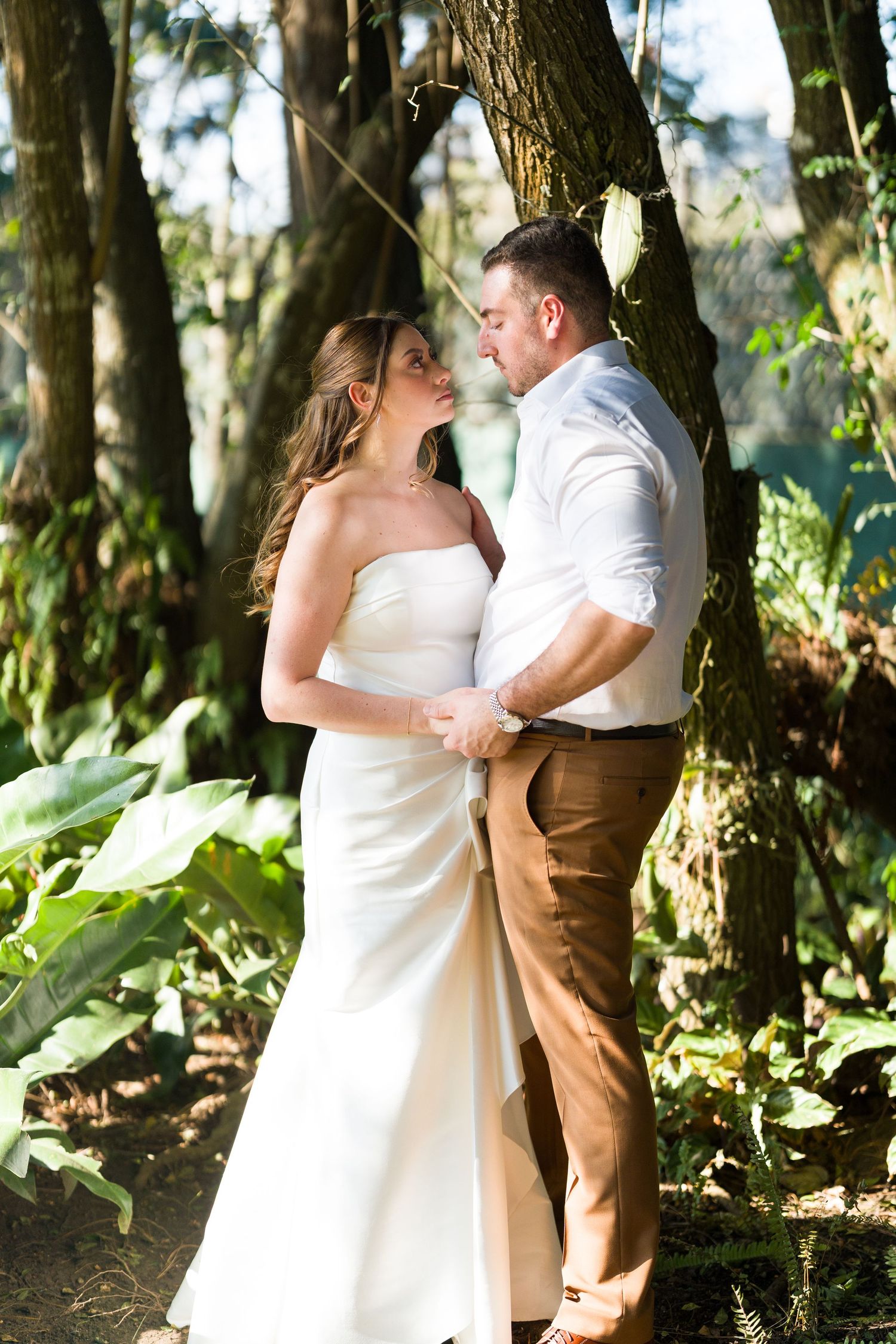 Romantic wedding portraits captured in a wooded outdoor setting.