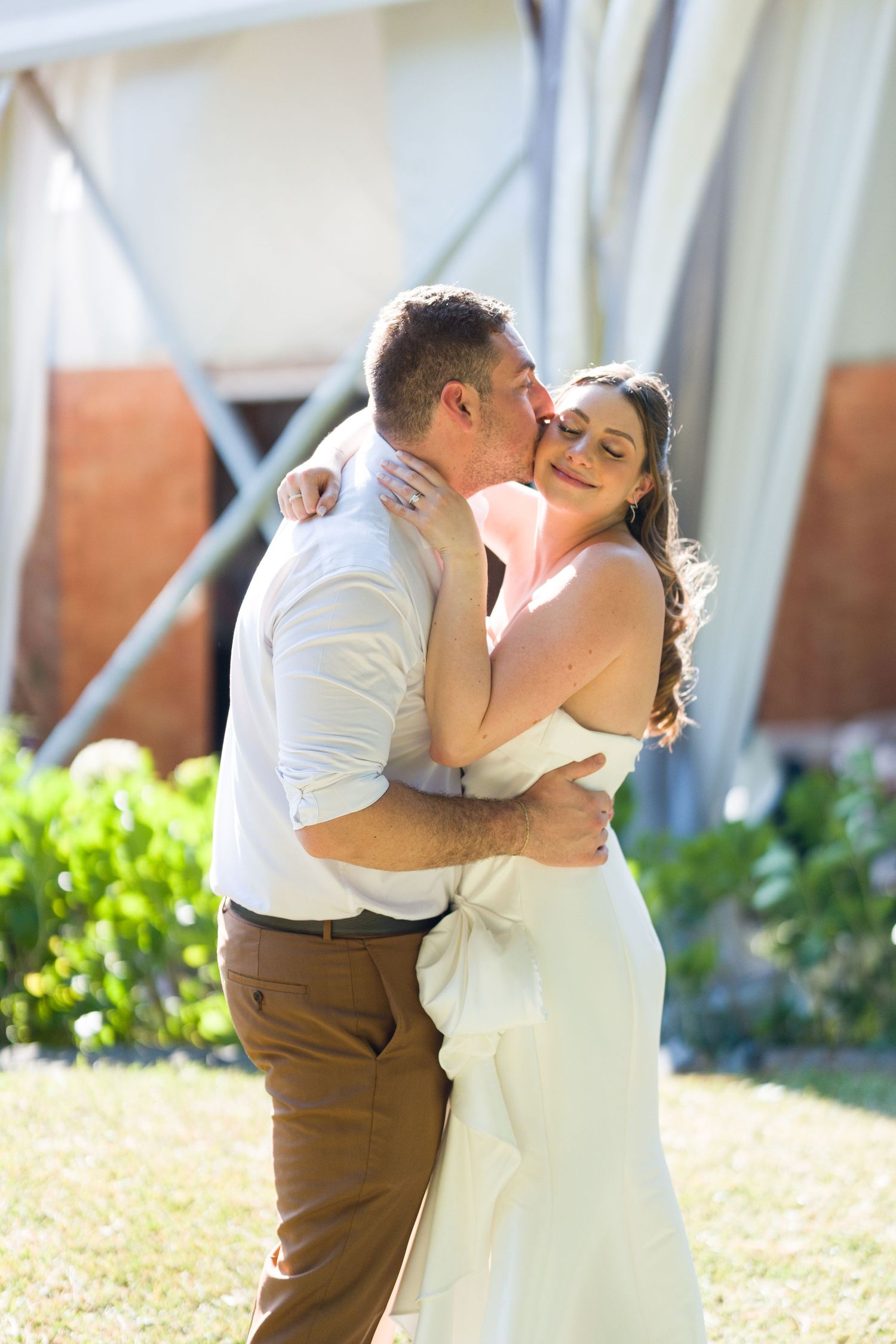 Romantic outdoor wedding photography session with couple embracing.