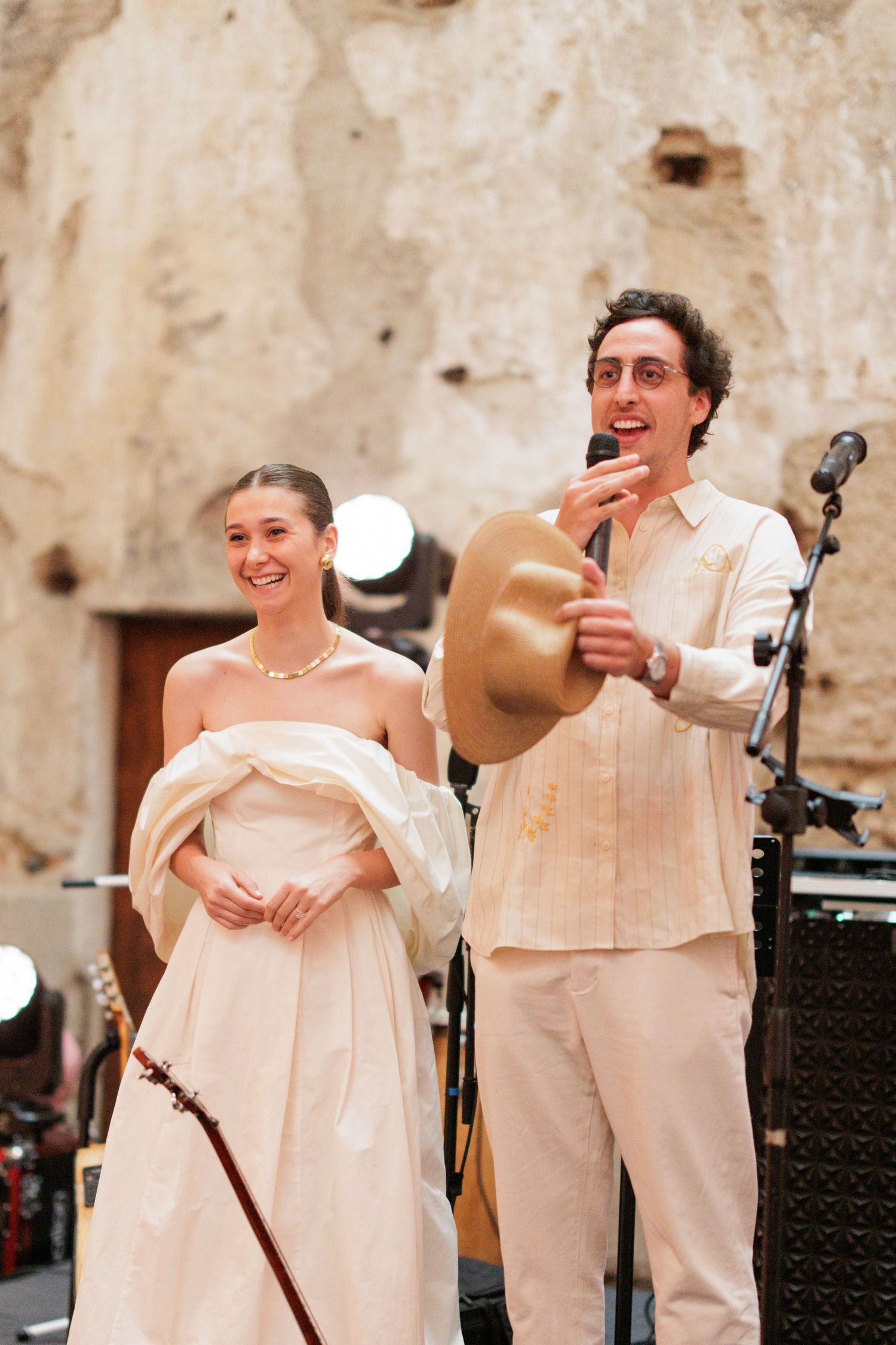 Couple shares a joyful moment while speaking at their wedding reception.