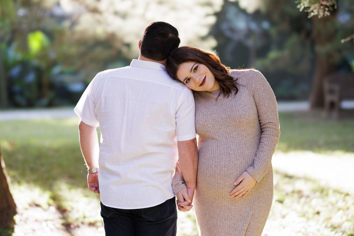 Casual outdoor family photoshoot with soft natural lighting.