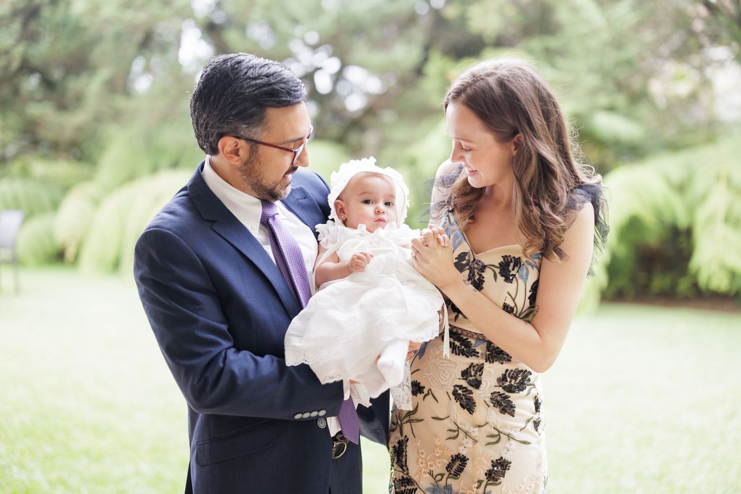 Family celebrating special occasion outdoors in formal attire.