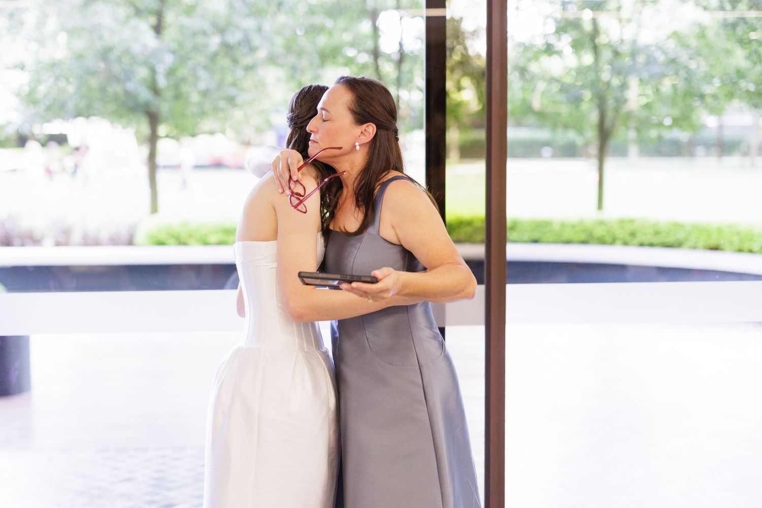 Wedding party members share emotional moments during celebration.