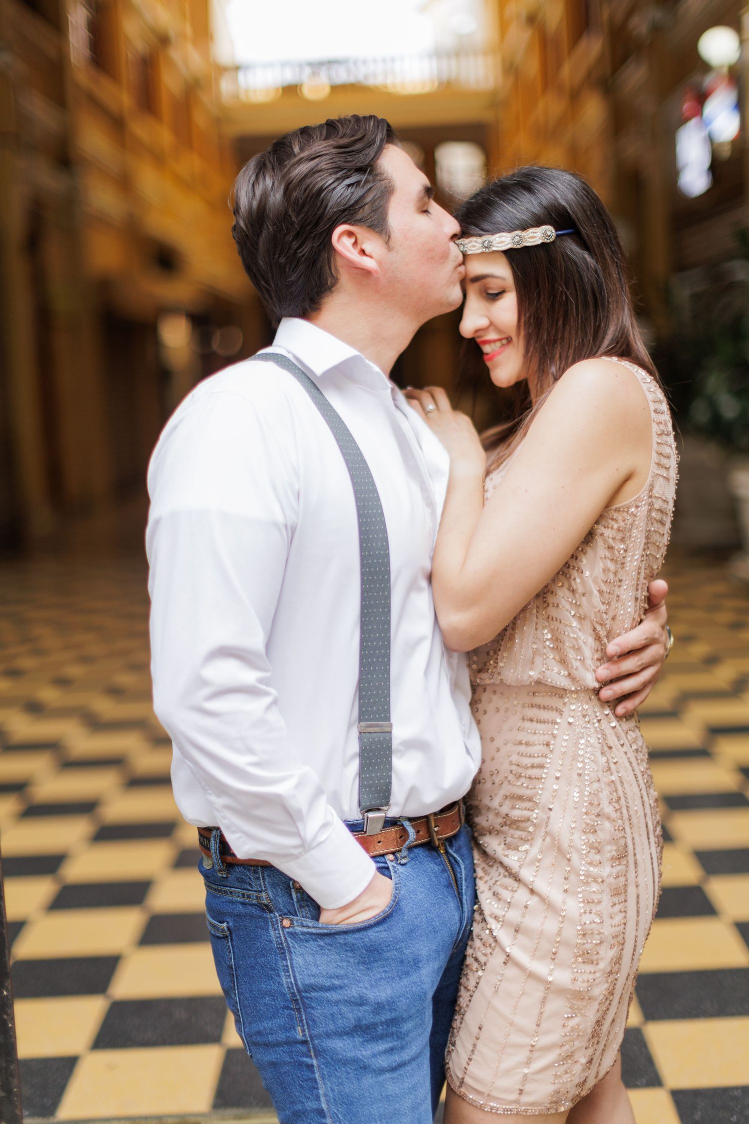 Romantic sequence in vintage setting with couple dancing on checkered floor.