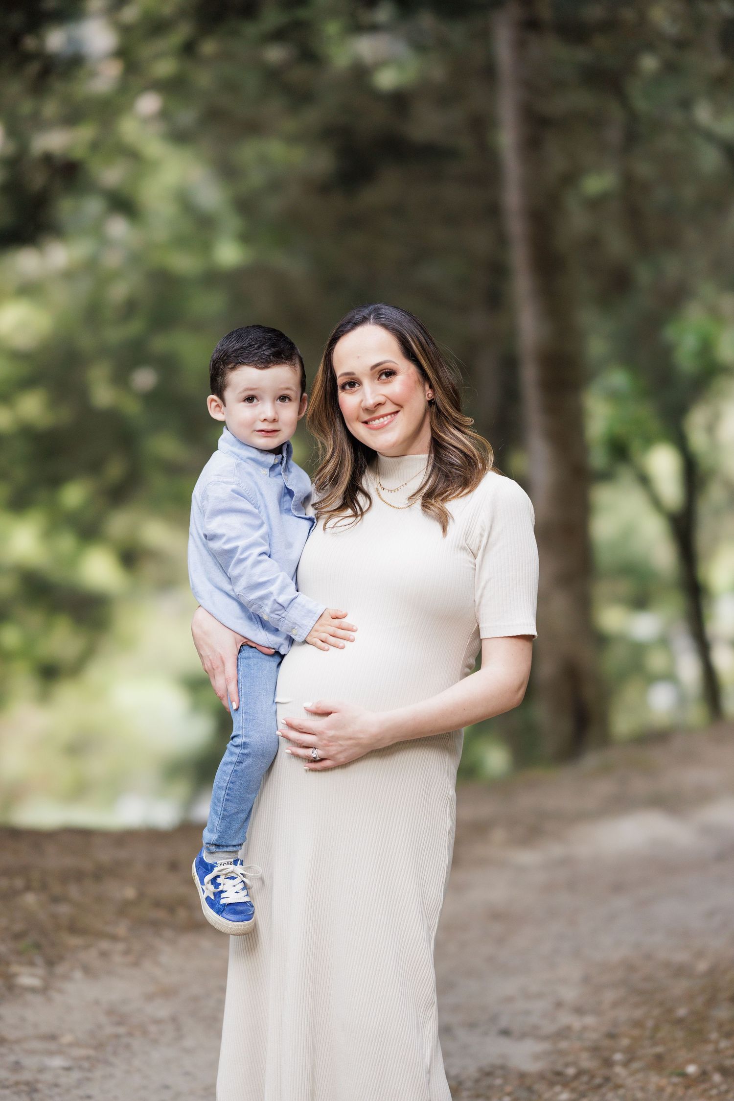 Family photos taken outdoors with a natural wooded background and soft lighting.