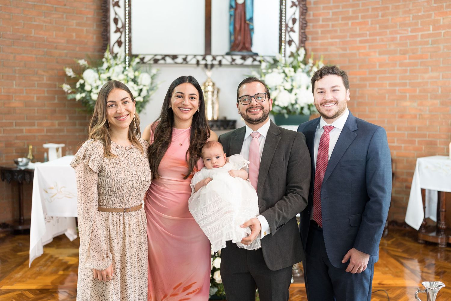 A celebration gathering in an indoor venue with exposed brick walls and formal attire.