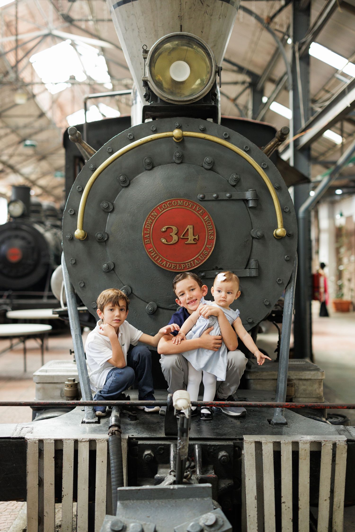 Vintage train photography session featuring locomotive number 34 with family posing on platform.
