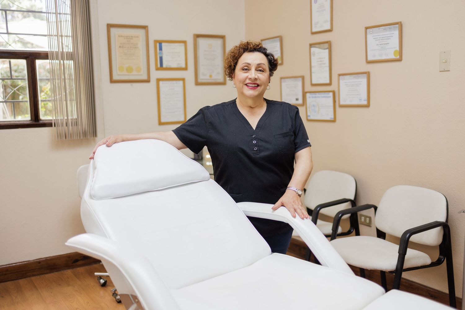 Massage therapy room with treatment table, wall decor, and professional equipment.