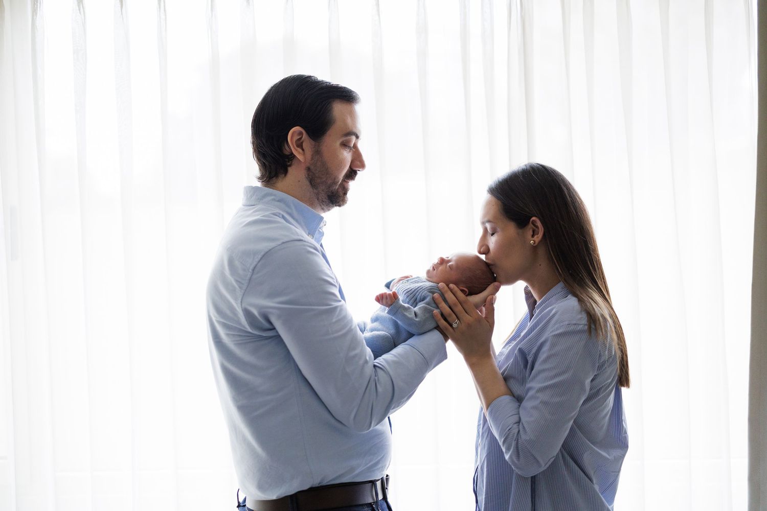 Series of intimate family moments against white curtains in natural light.