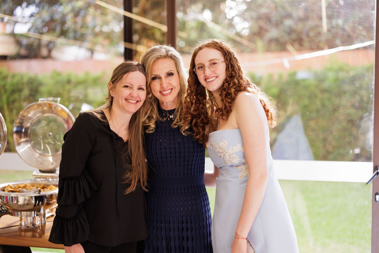 Friends gathering outdoors for a casual celebration or event.