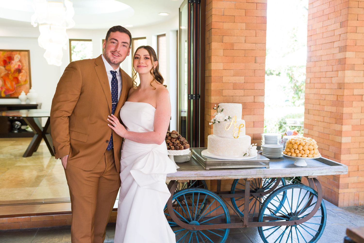 Wedding couple shares intimate moment in rustic brick venue with vintage decor.