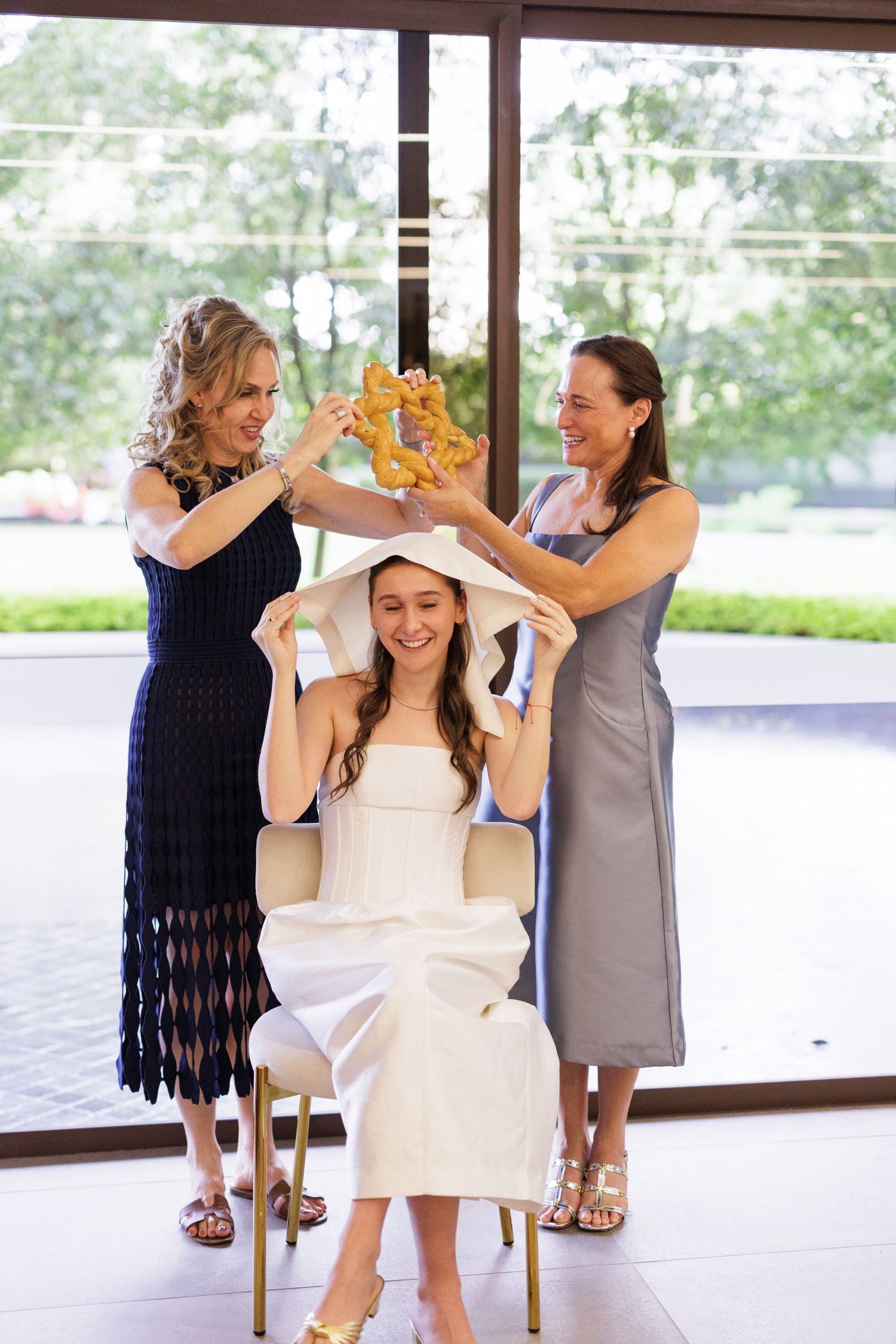 Wedding celebration scene with attendees in navy and white dresses.