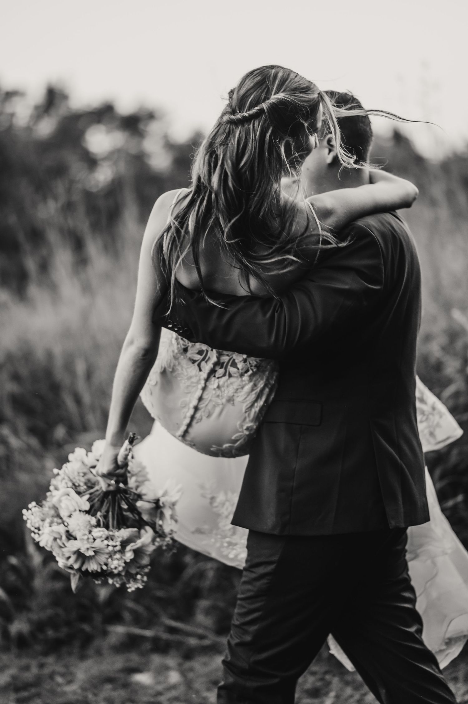 Bride and groom portrait of bride being carried away at Acorn Ridge wedding venue in Sullivan, Indiana. Indianapolis wedding photographer