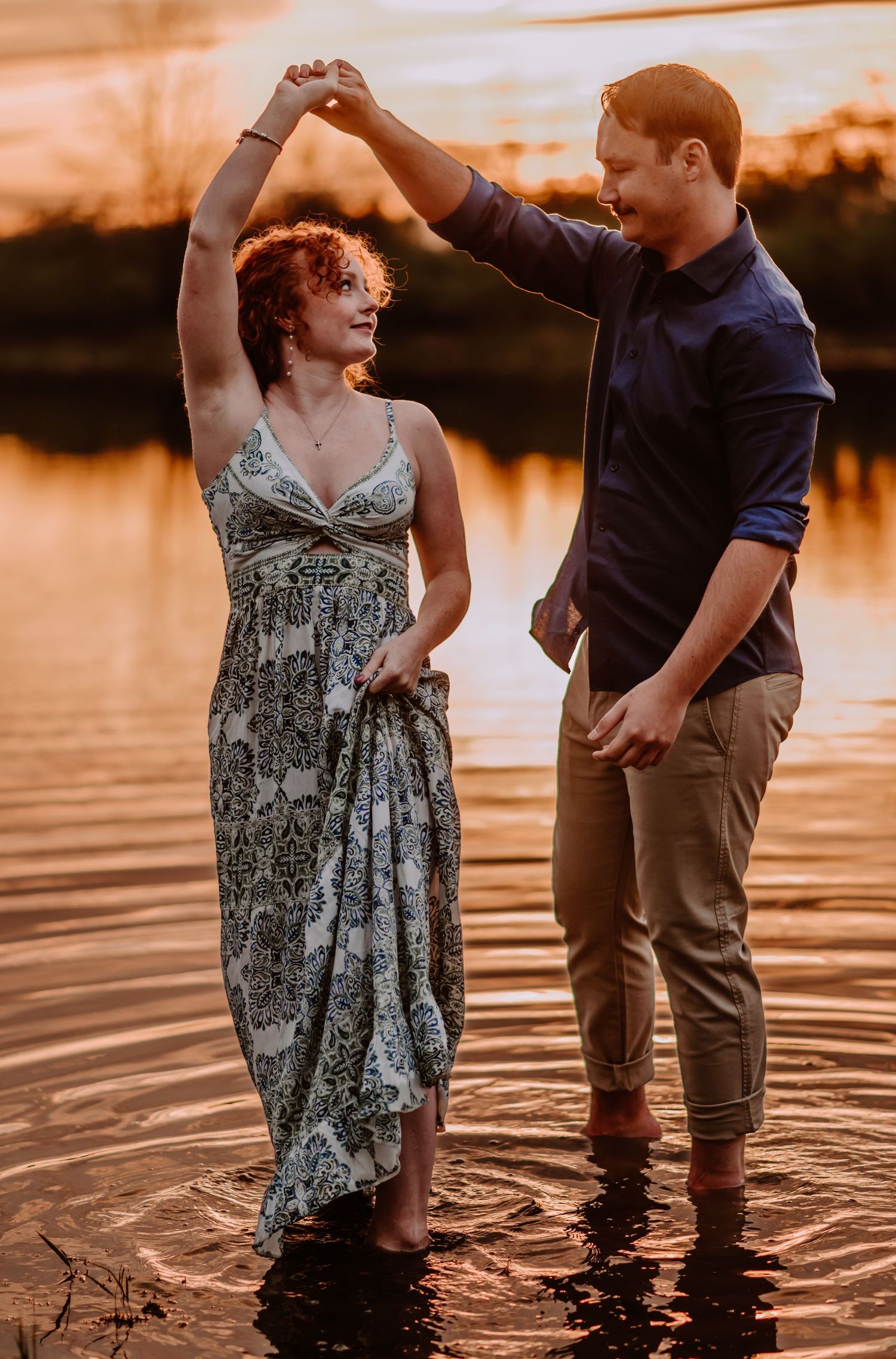 Golden hour engagement session of couple dancing in the water. Indianapolis wedding photographer