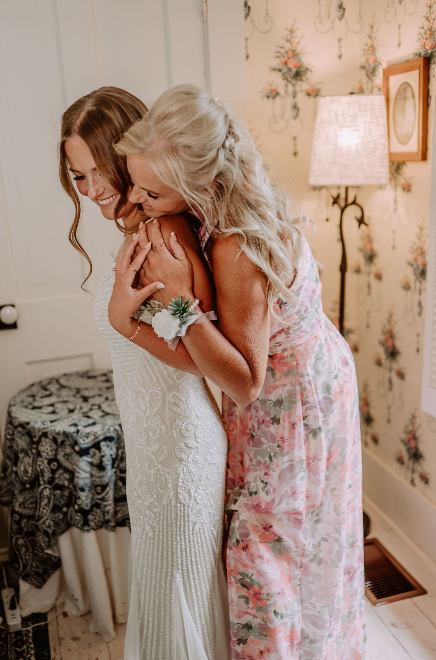 Bride and mother embrace while getting ready for wedding ceremony at The Red Barn at Sycamore Farm. Terre Haute wedding photographer