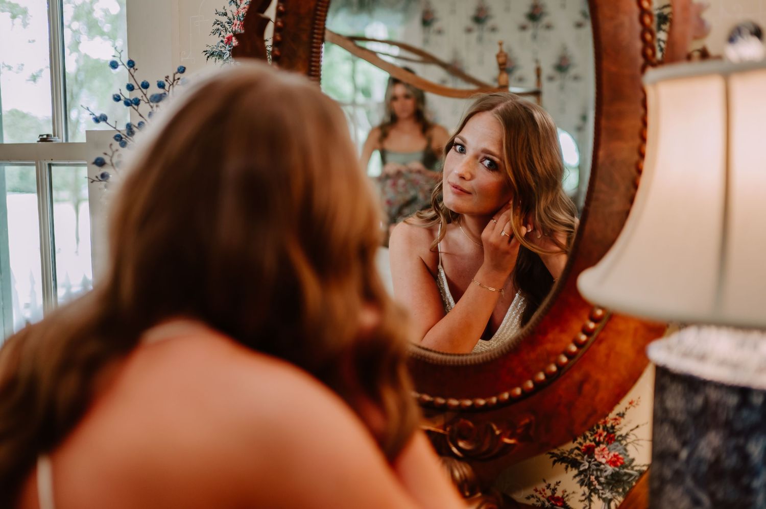 Bride getting ready in the mirror at The Red Barn at Sycamore Farm. Terre Haute wedding photographer