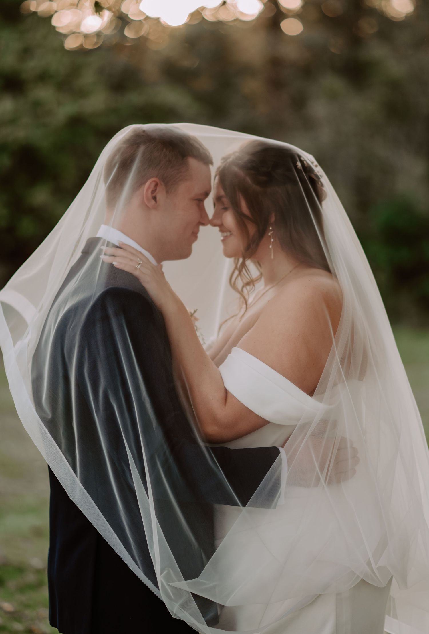 Under the veil shot of bride and groom portrait at Laurel Mill wedding barn in Heltonville, Indiana. Indianapolis wedding photographer