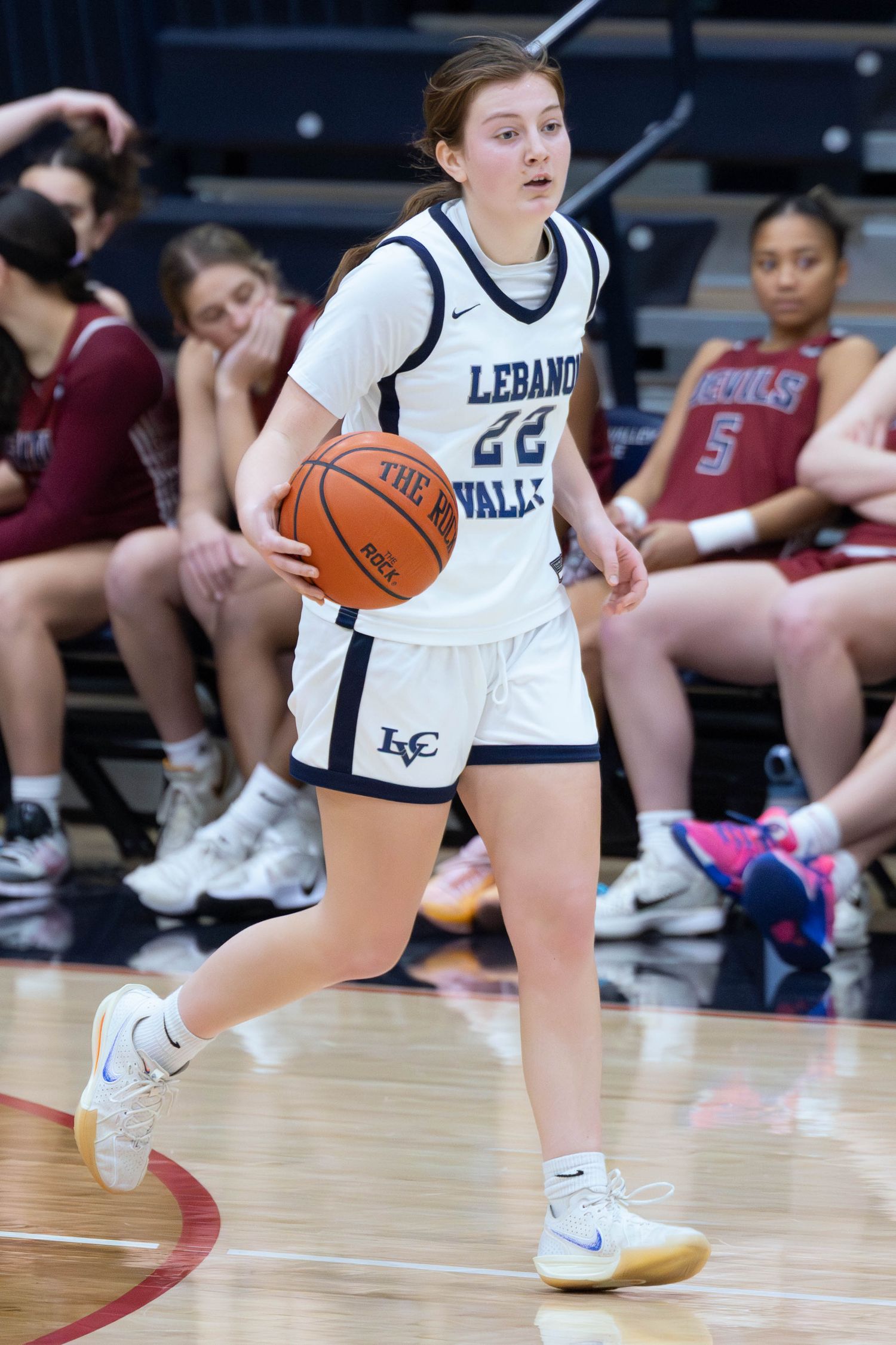 Lebanon Valley College #22 women's basketball player dribbles the ball during a college game.