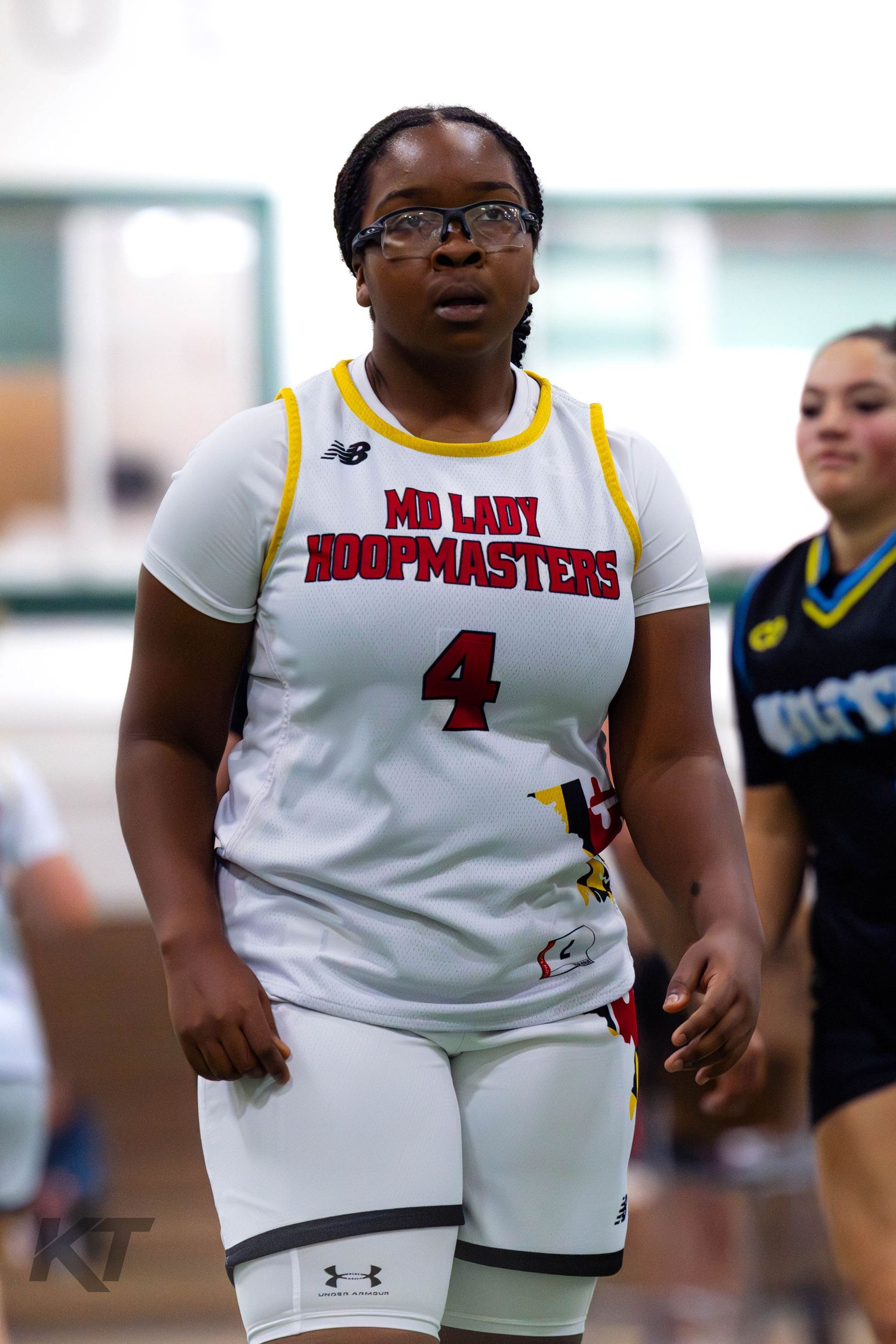 Female basketball player #4 in white MD Lady Hoopmasters jersey playing in an indoor gymnasium game.