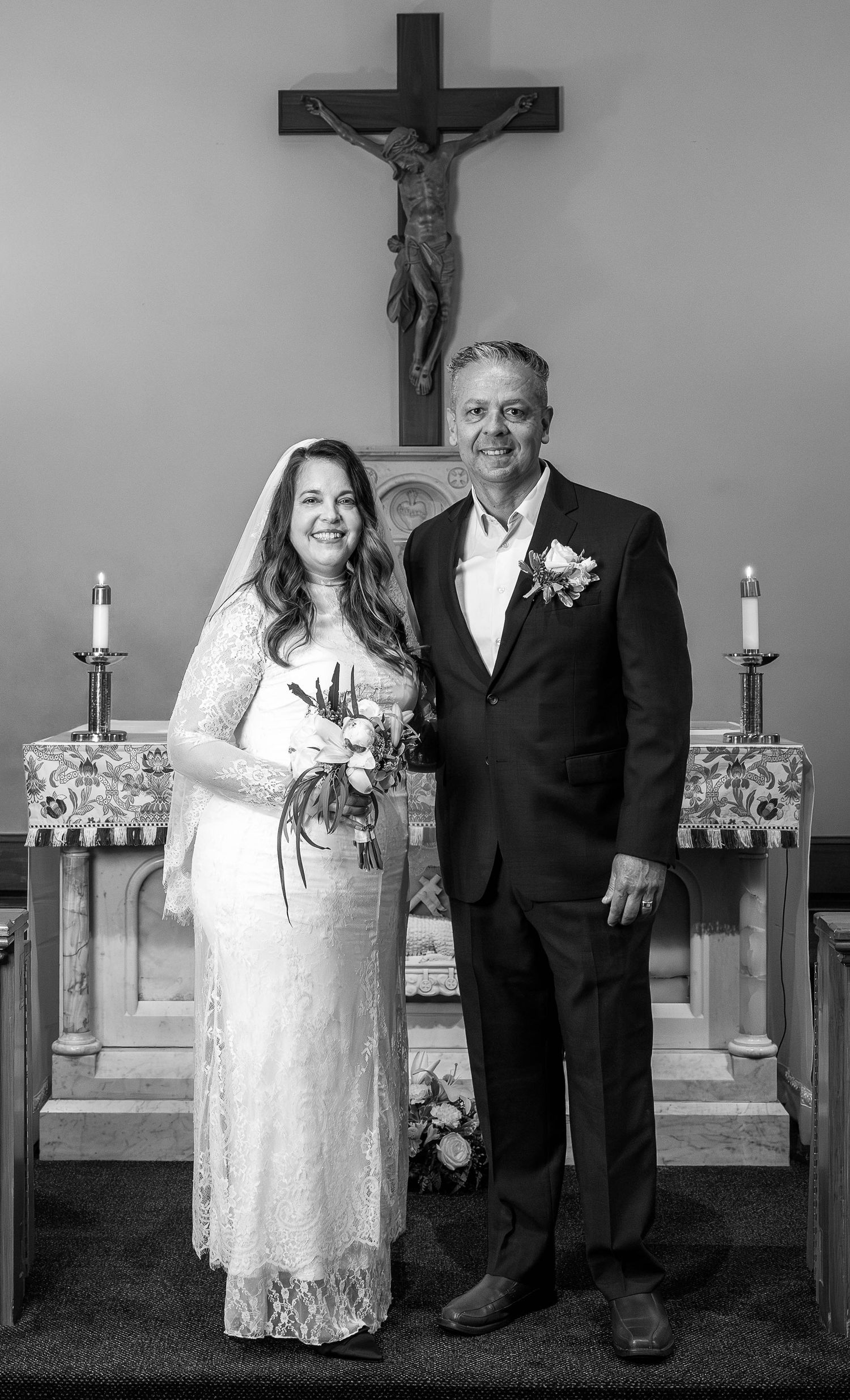 Catholic newlyweds share a joyful moment  after their wedding Mass, celebrating their sacred marriage.