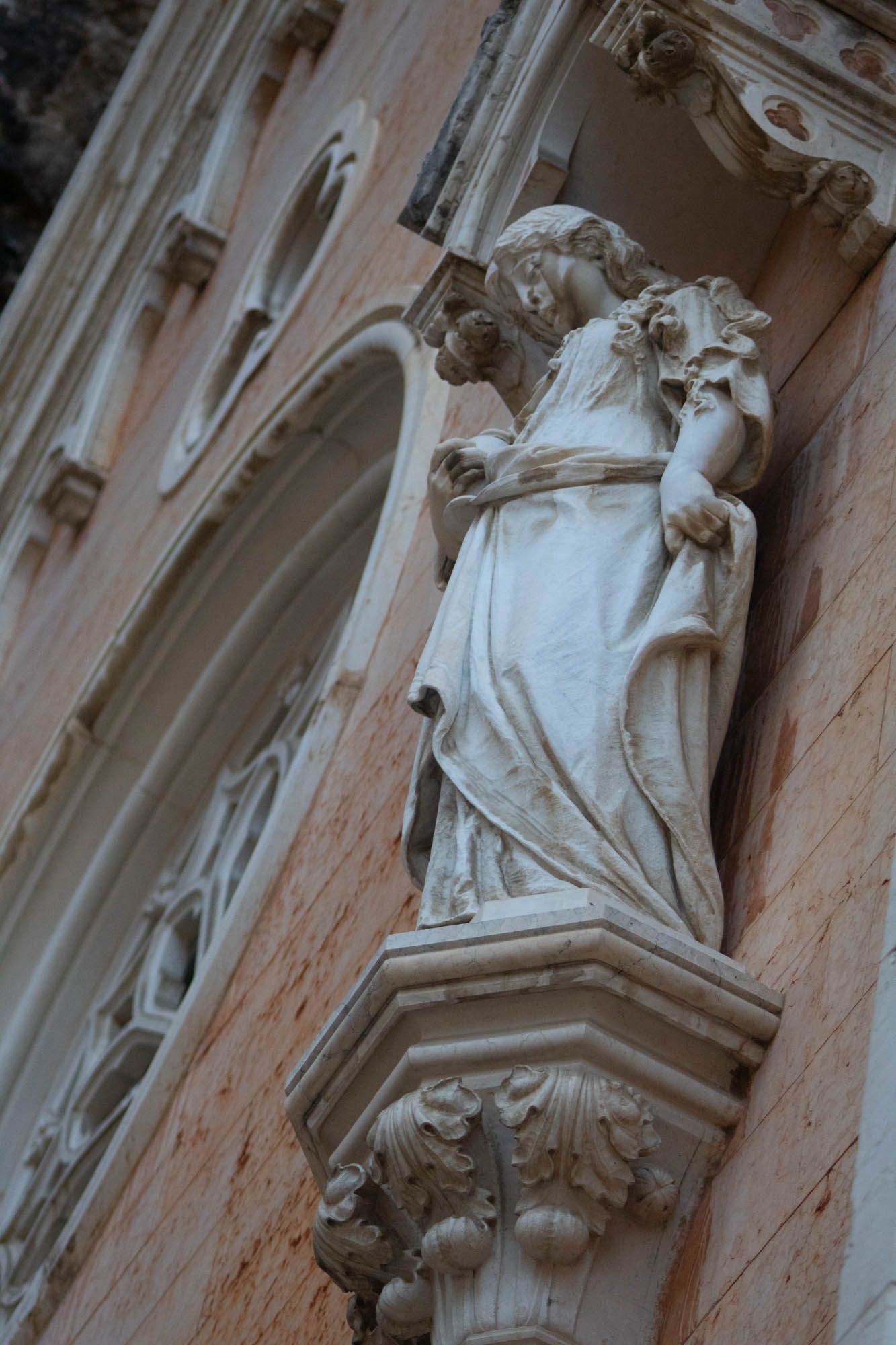 Detailed architectural stone carvings and sculptures on a historic building facade.