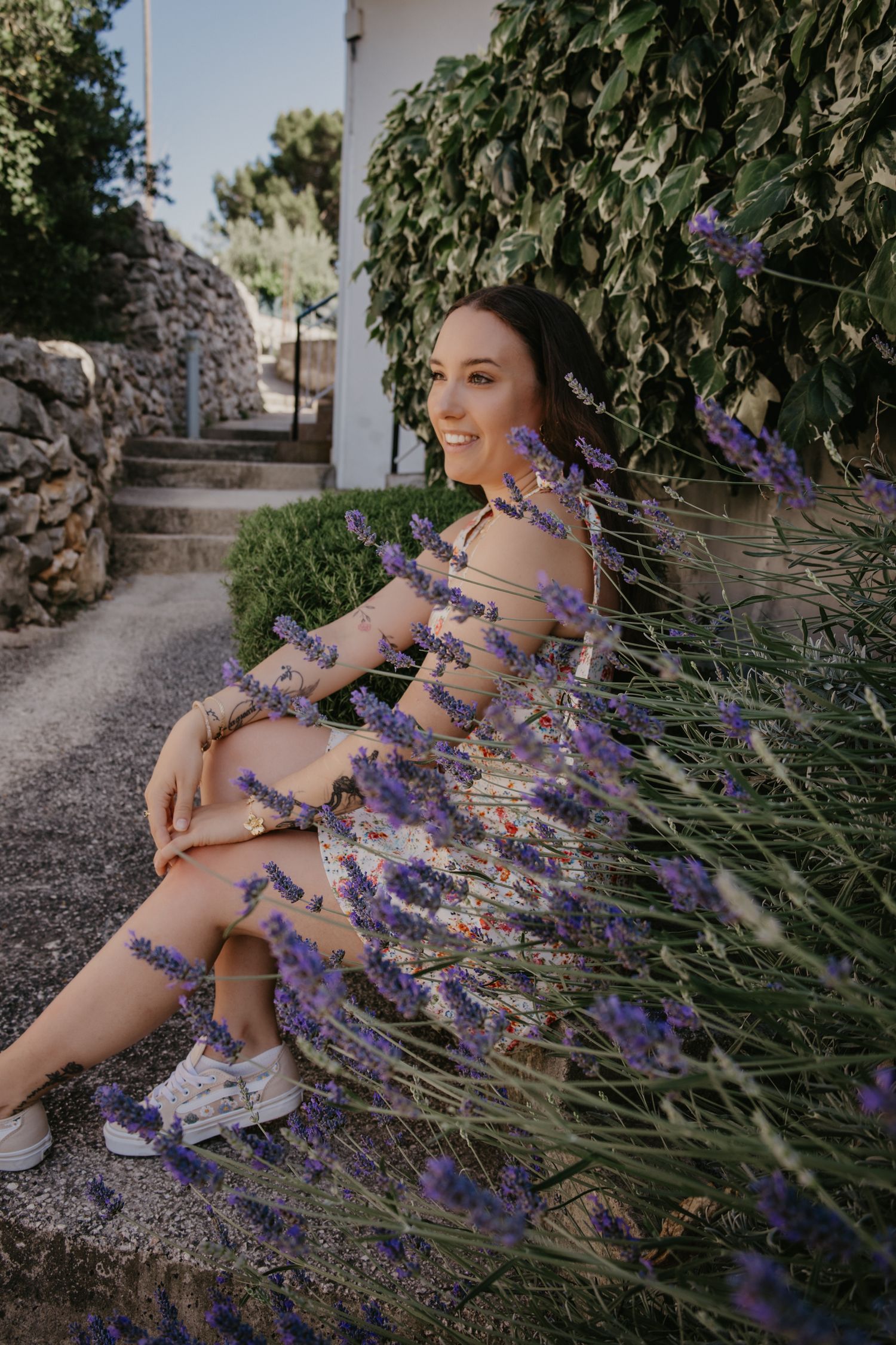 A floral summer photoshoot with lavender flowers in a garden setting.