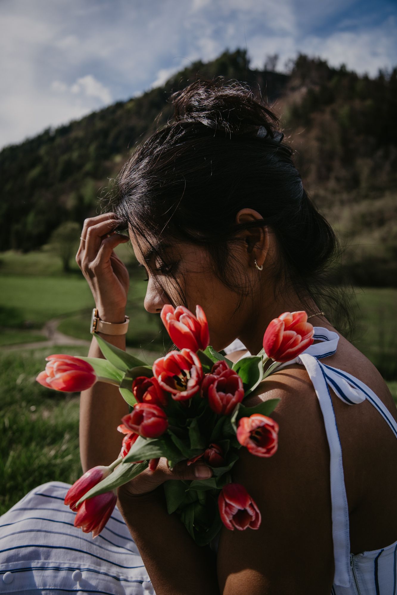 Artistic photo series with red tulips and mountain scenery in background.