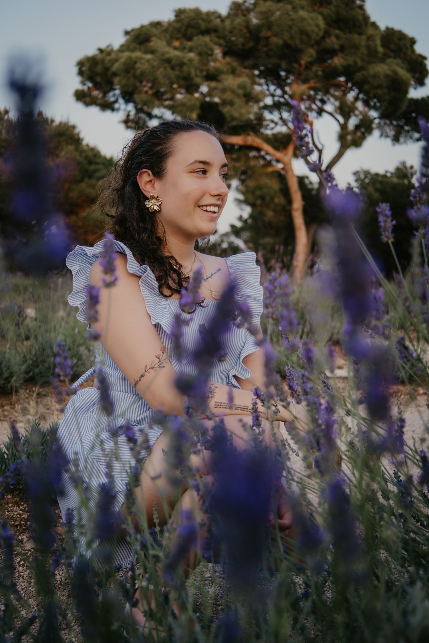 Joyful summer portraits among blooming purple lavender and pine trees.