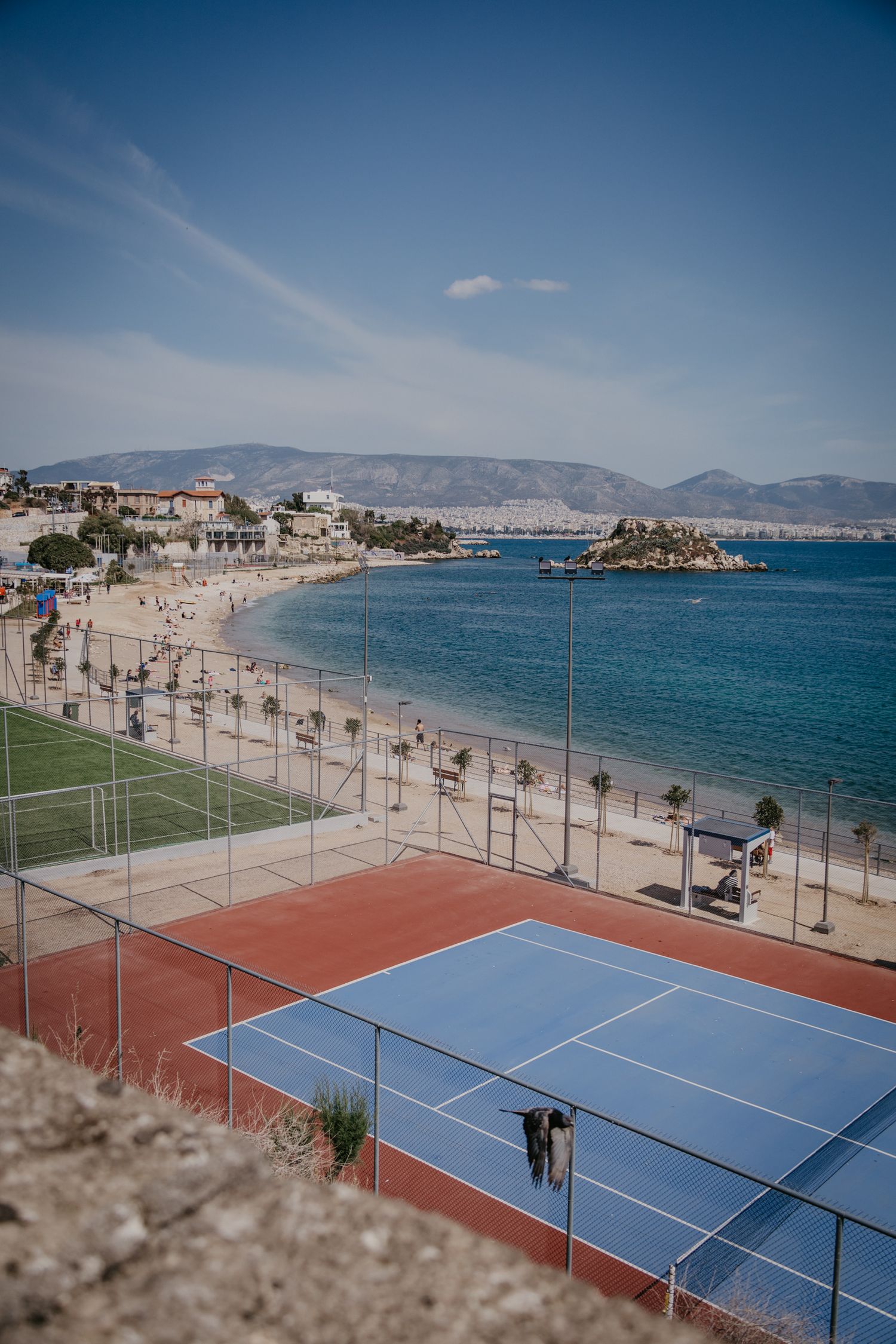 Beachfront tennis courts with stunning Mediterranean Sea views in Greece.