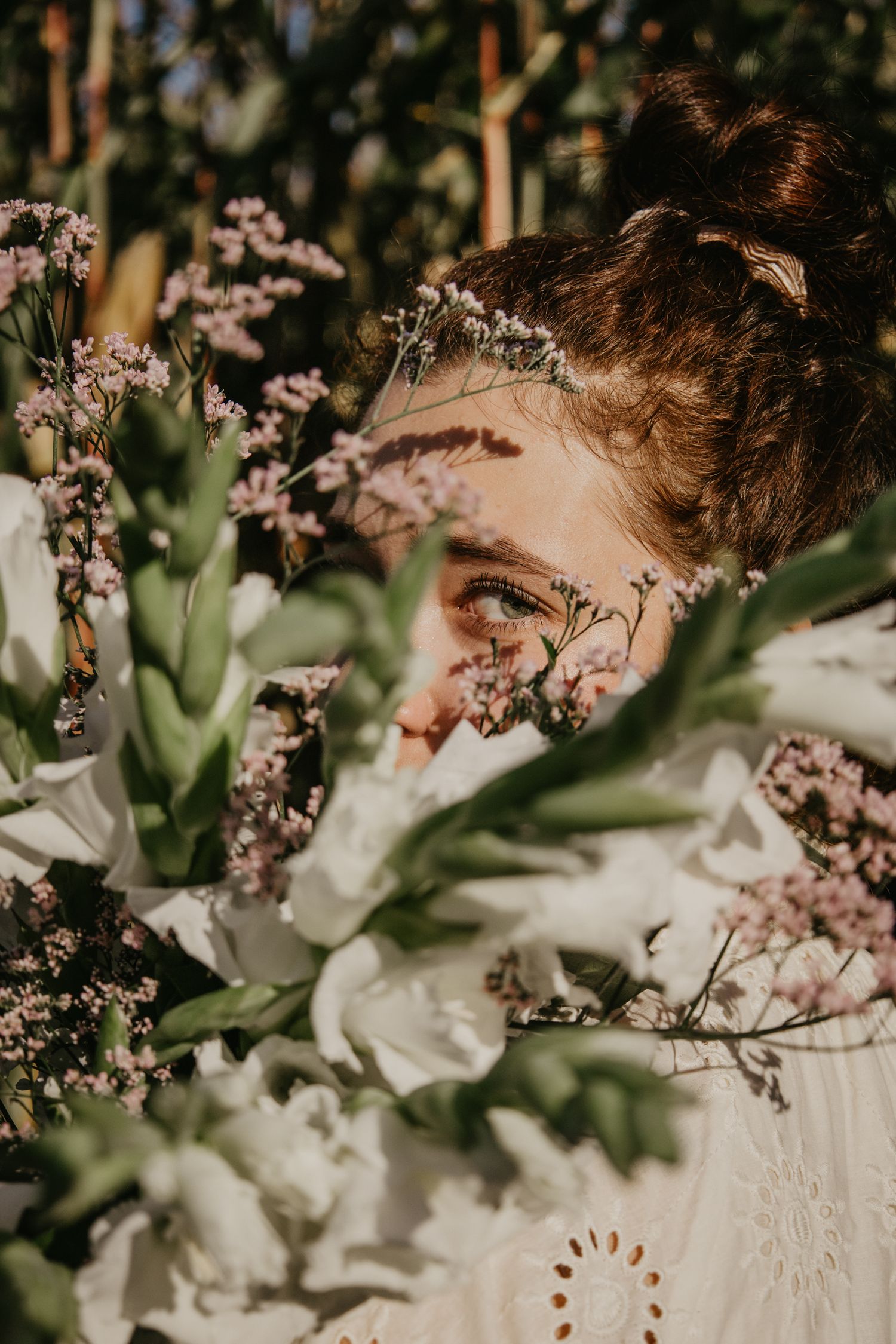 Delicate white flowers frame a dreamy vintage-inspired portrait.