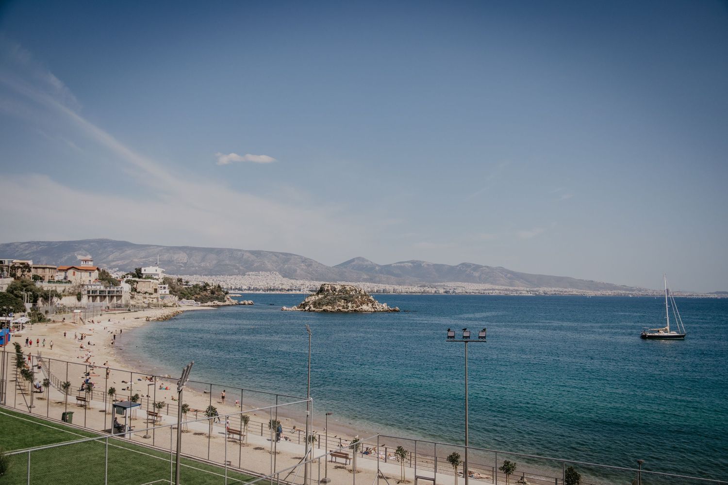 Mediterranean coastal panorama with pristine blue waters and sandy beach.