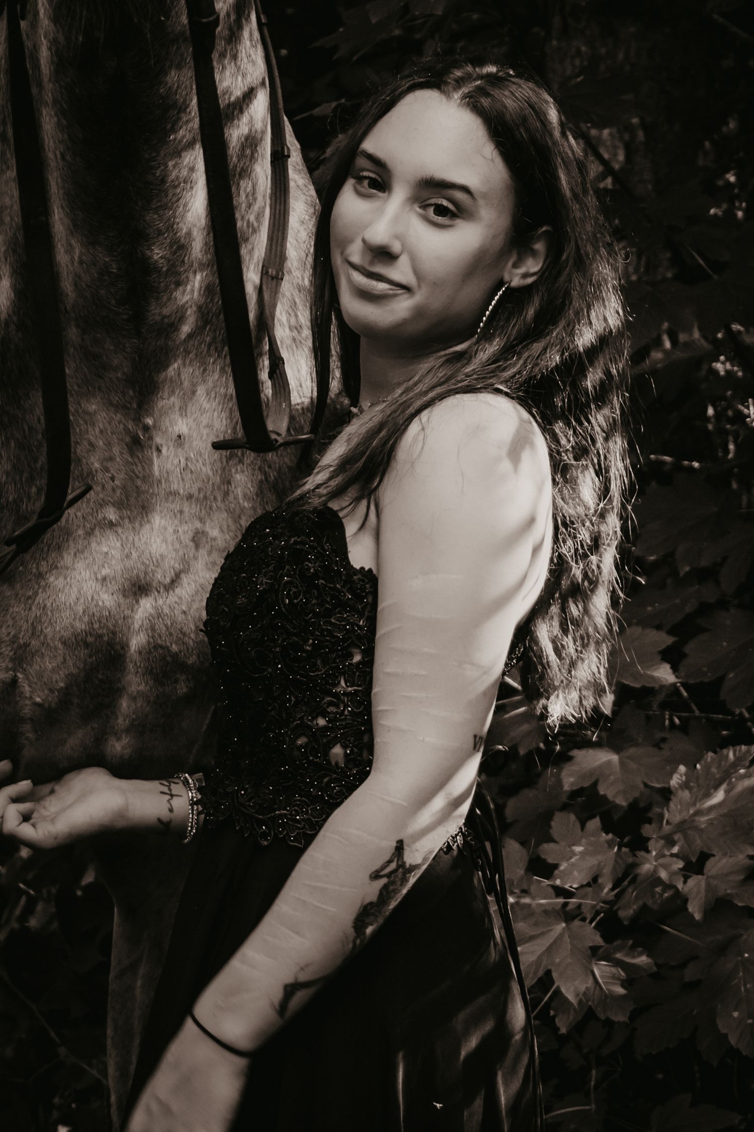 Artistic black and white portrait in a natural woodland setting.