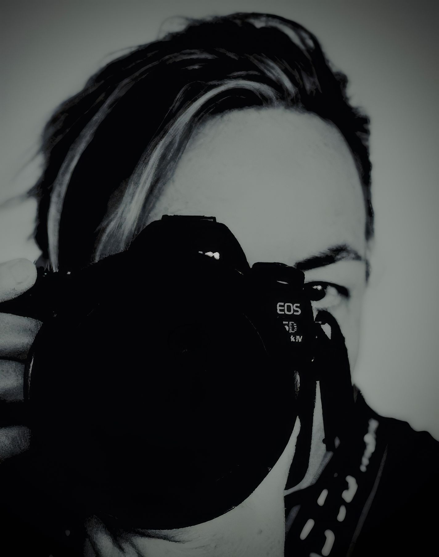 Black and white self-portrait of a photographer holding a Canon EOS camera up to their face, obscuring most of their features.