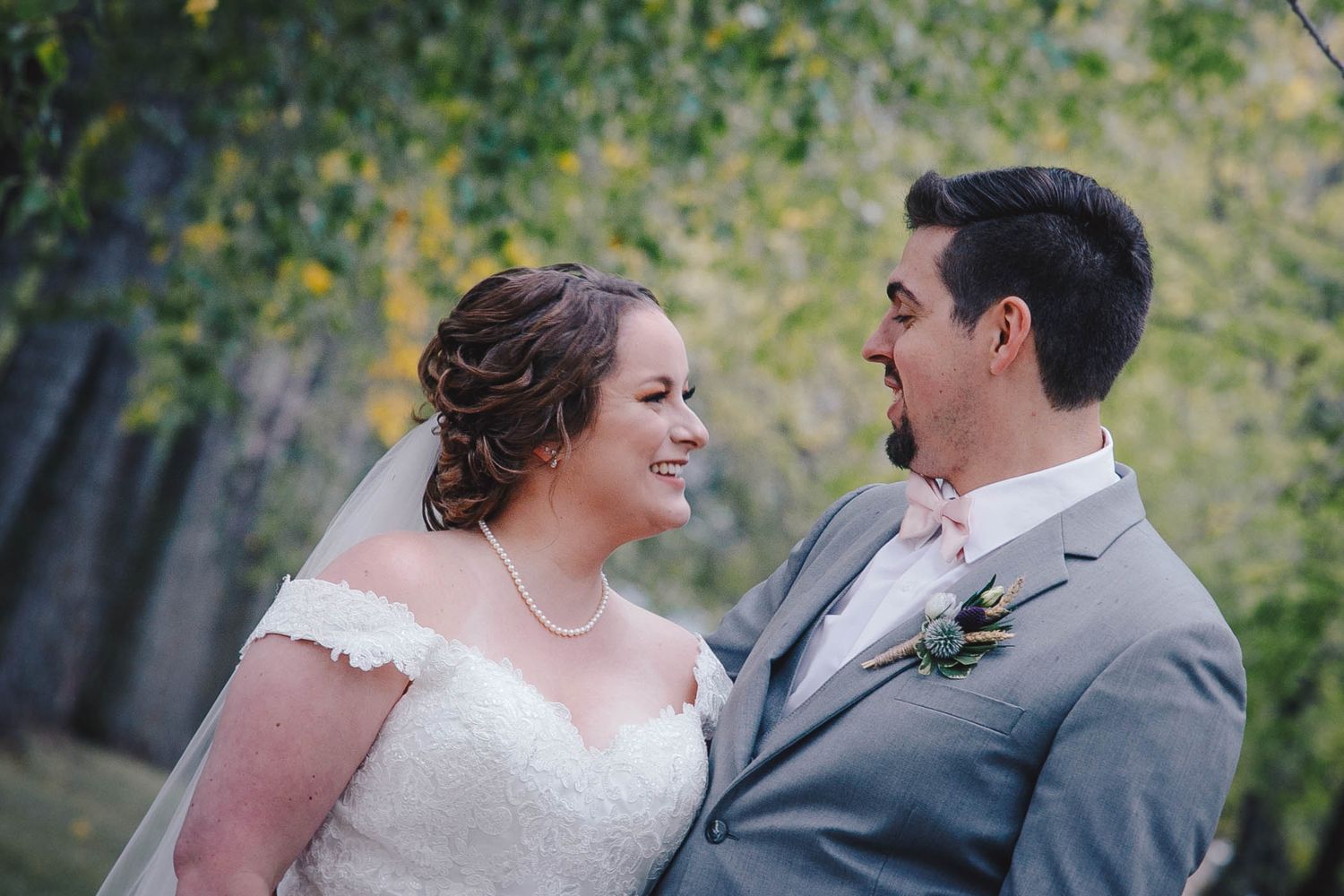 A romantic wedding moment captured in an outdoor garden setting.