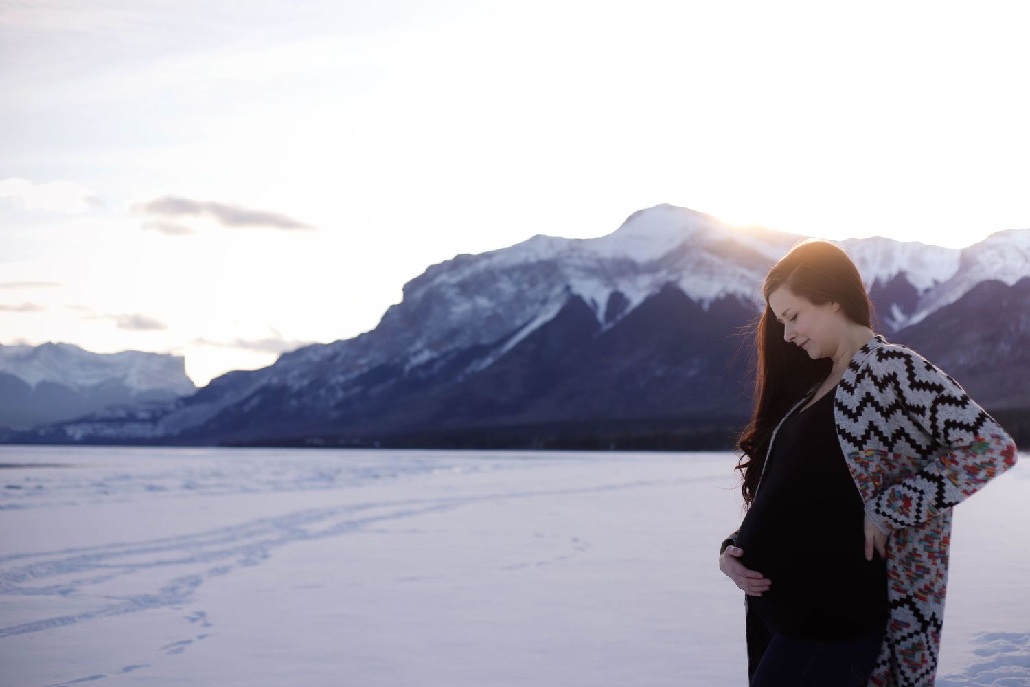 A romantic photoshoot against a stunning mountain landscape at dusk.