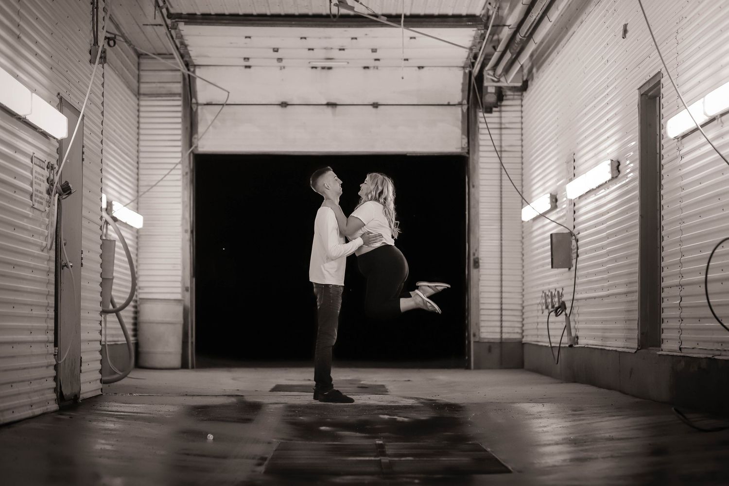 Black and white photograph showing dramatic lighting inside an empty theater space.